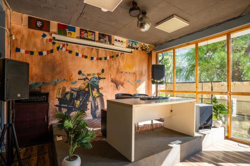 a room with a desk and a wall with a mural at Alt Life Manali, Old Manali in Manāli