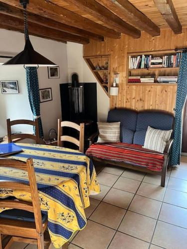 un salon avec un lit et un canapé dans l'établissement Petit chalet de montagne, à Mizoën