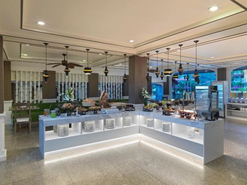 a room with a counter with food on display at Chanalai Flora Resort, Kata Beach in Kata Beach