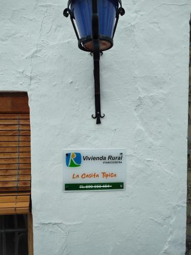a sign on the side of a building with a street light at La Casita Tipica in Zuheros