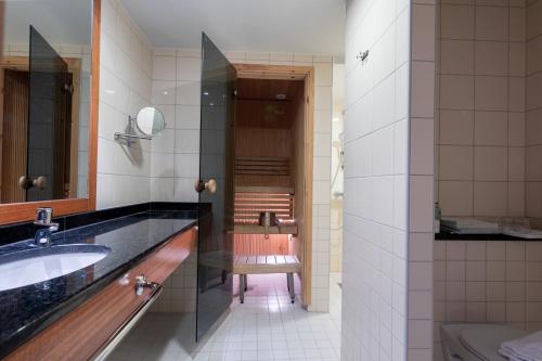 a bathroom with a sink and a toilet at Hotel Oscar in Varkaus