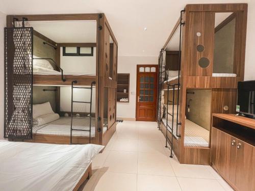 a dorm room with bunk beds and a sink at Chi's House Cao Bang in Hoàng Ngà