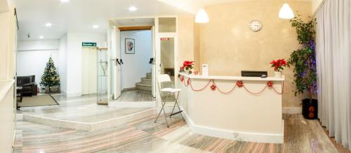 a lobby with a christmas tree and a reception counter at Hotel Del Viale in Agrigento