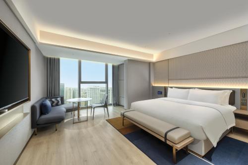 Ein Bett oder Betten in einem Zimmer der Unterkunft Echarm Plus Hotel - Xi'an Daminggong West Subway Station