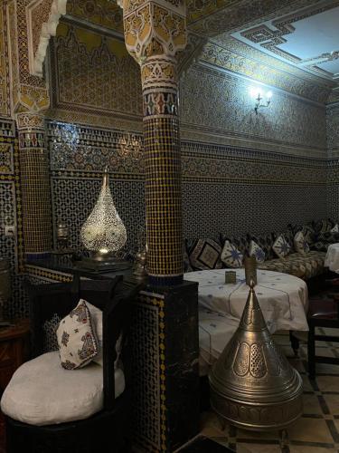 a room with a bed and a lamp in it at Riad Lahboul in Meknès