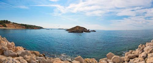 an island in the middle of the water with rocks at Meliá South Beach in Magaluf