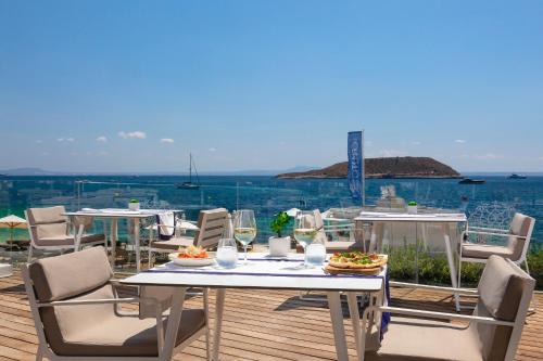 a table with plates of food on it with a view of the ocean at Meliá South Beach in Magaluf