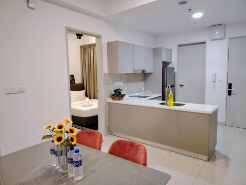 a kitchen and dining room with a table and chairs at Trion Residence Kuala Lumpur BY Sky Rainbow in Kuala Lumpur