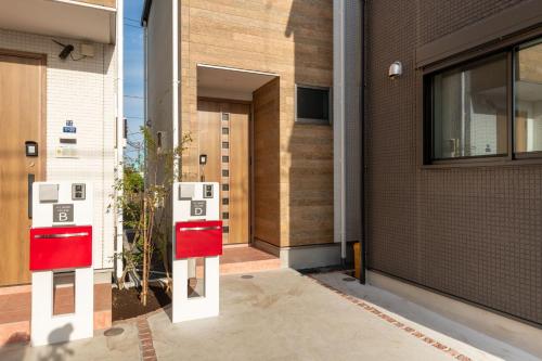 a building with two parking meters in front of a building at Ici Japon Village in Tokyo