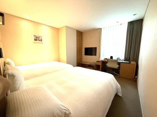 Postel nebo postele na pokoji v ubytování Acube Hotel Dongdaemun