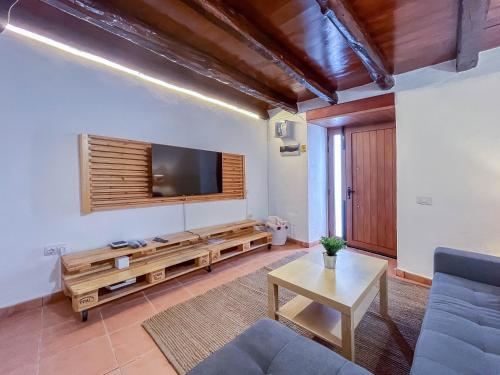 a living room with a flat screen tv on the wall at Casa Libelvik en pleno centro Galdar con Terraza in Gáldar