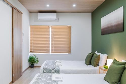 a bedroom with a bed and a window with at MIYU 繁花 near USJ in Osaka