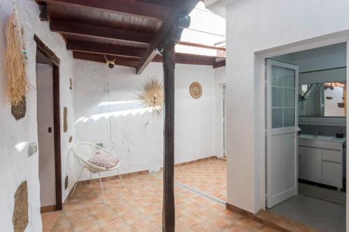 a kitchen with a table and a chair in a room at Casa Libelvik en pleno centro Galdar con Terraza in Gáldar
