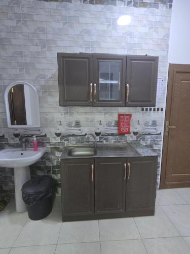 a kitchen with a sink and a counter top at شقق عبدالله in AlUla