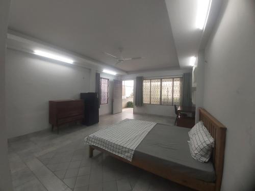 a bedroom with a bed and a dresser in a room at Timmy's house in Ho Chi Minh City