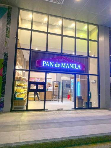 a store front with a sign that reads pan de manilla at Mactan Newtown - 1BR Stunning Ocean View and City View in Mactan