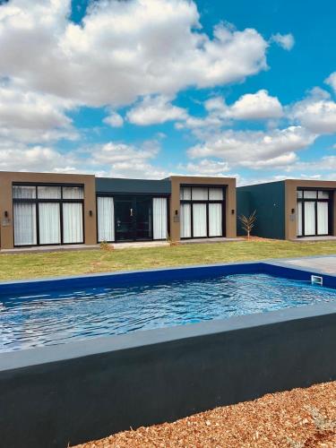 a large swimming pool in front of a building at Cellar Pods Blue in Robertson