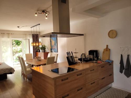 a kitchen with a large wooden island in a room at Apartments Chiara mit Meerblick und Pool und Jacuzzi in Lovran