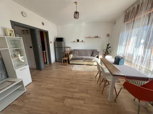 a living room with a table and a couch at RomAnna in Domegge di Cadore