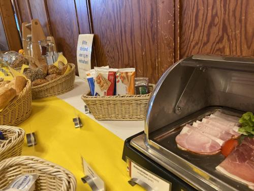 a table with a counter with a ham in a toaster at Hotel Gasthaus Schützen in Freiburg im Breisgau