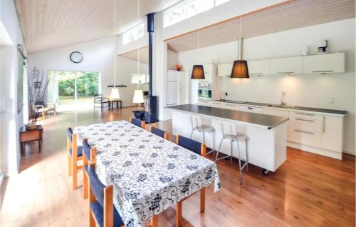 a kitchen and dining room with a table and chairs at Holiday Home Eneb in Dagstrup