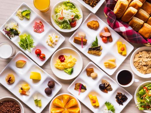 a table filled with appetizers and plates of food at Hotel Green Plaza Hamanako in Hamamatsu