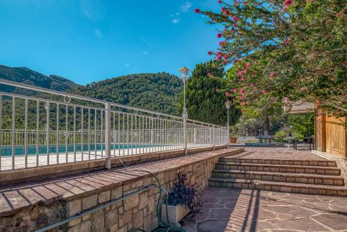 a fence with stairs next to a swimming pool at Villa Montgrau in Llano de Gorra