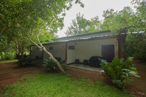 a small house in the middle of a forest at Lake Side Resort in Kekirawa