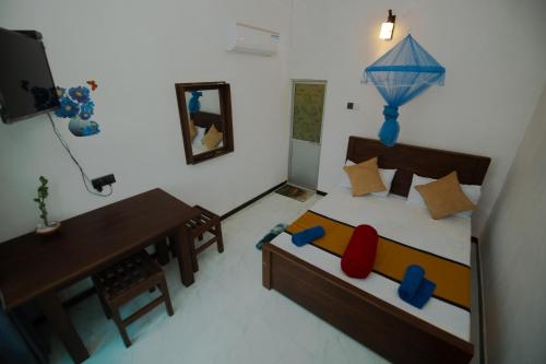 a model of a bedroom with a bed and a desk at Lake Side Resort in Kekirawa