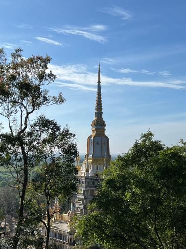 a tall building with a steeple on top of it at โรงแรมตะวันไท in Ban Krabi Yai