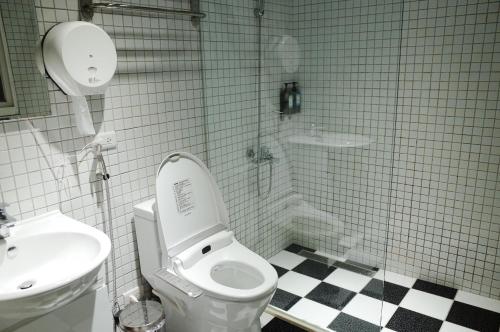 a bathroom with a toilet and a sink at Bao Dao Da Lou in Suao