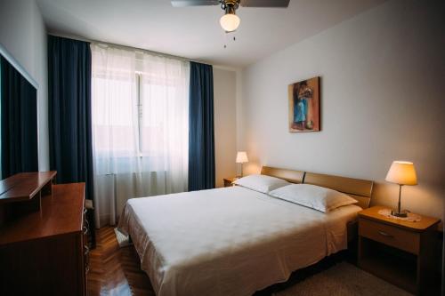 Postel nebo postele na pokoji v ubytování Apartments Ivana