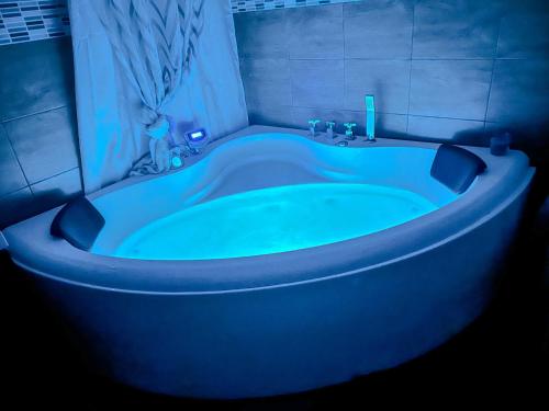 a blue bath tub in a bathroom with a blue light at Casa Iraci La Nostra Sicilia in Trapani