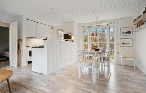 a kitchen and dining room with a table and chairs at Stunning Home In Allingåbro With Wifi in Allingåbro