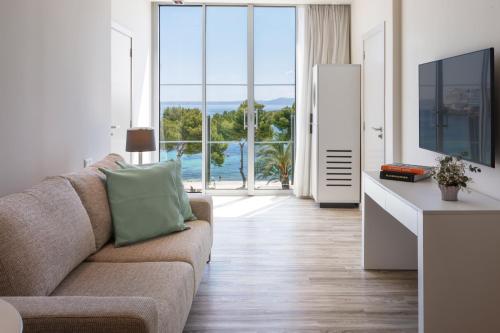 a living room with a couch and a large window at Meliá South Beach in Magaluf