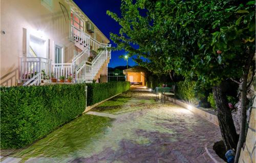 a cobblestone alley between two buildings at night at Cozy Apartment In Dubravka With Sauna in Gruda