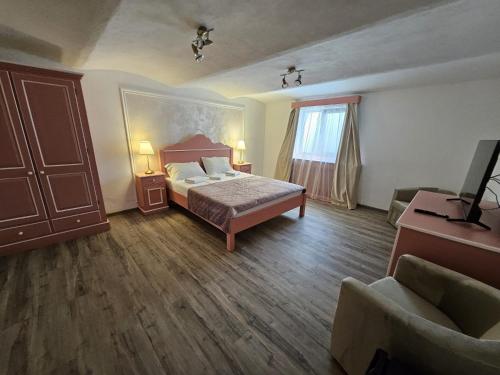 a bedroom with a bed and a window and a couch at Casa Raduly - Apartament Demisol in Sibiu