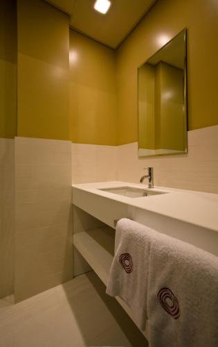 a bathroom with a sink and a mirror at Eos Hotel in Lecce