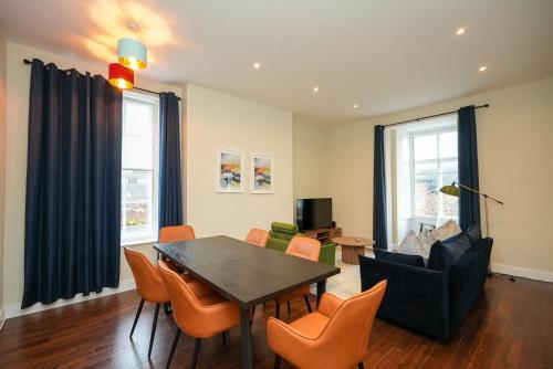 a living room with a table and chairs at Luxury Two Bedroom Apartment Liverpool in Liverpool