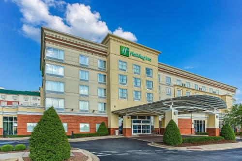 a hotel with a sign on the front of it at Holiday Inn Louisville Airport - Fair/Expo by IHG in Louisville