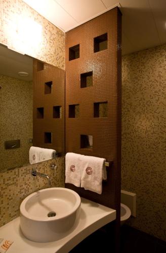 a bathroom with a sink and a mirror at Eos Hotel in Lecce
