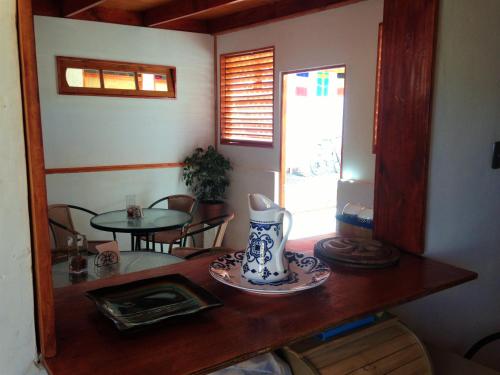 a room with a wooden table with a vase on it at Hostal Siete Colores in San Pedro de Atacama