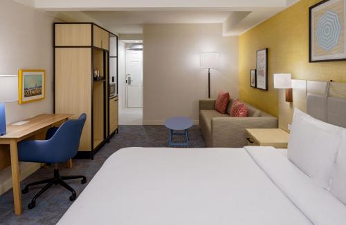 a hotel room with a bed and a desk at Hilton Garden Inn Dana Point Doheny Beach in Dana Point