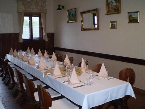 a long table with napkins on it in a room at Berki Vendéglő és Hotel in Körmend