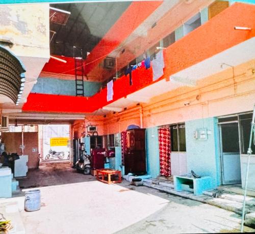 an empty building with flags hanging from the ceiling at Sri Guru Nivas in Vellore
