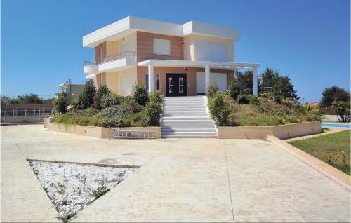 a large house with a staircase in front of it at 7 Bedroom Cozy Home In Preveza in Kanali