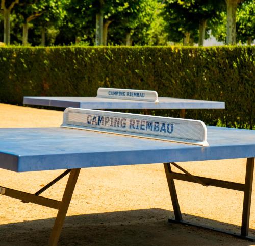 two signs on top of a picnic table at Camping Riembau in Platja  d'Aro
