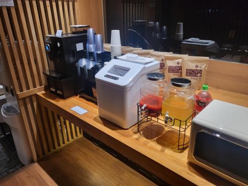 a coffee maker sitting on a counter next to a microwave at Incheon Airport Hotel Seattle in Incheon