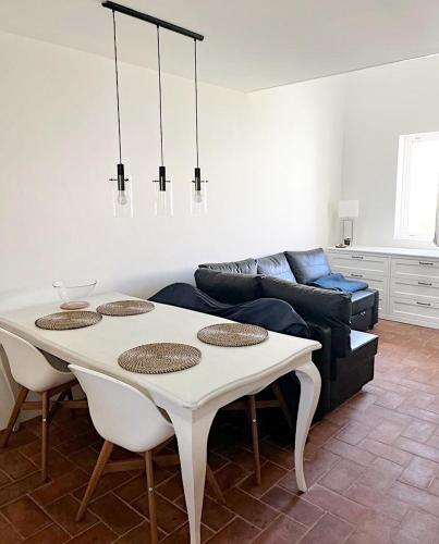 a living room with a table and a couch at Apartamento Convento das Bernadas Tavira in Tavira