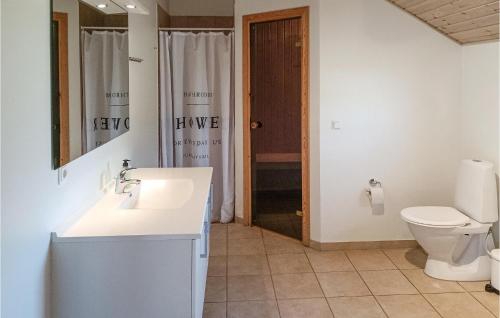 a bathroom with a white sink and a toilet at Pet Friendly Home In Köpingsvik in Köpingsvik